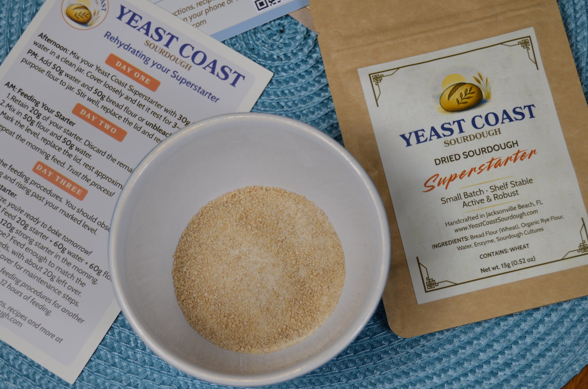 Yeast Coast dried sourdough superstarter in a bowl with packaging and instructions on a blue background