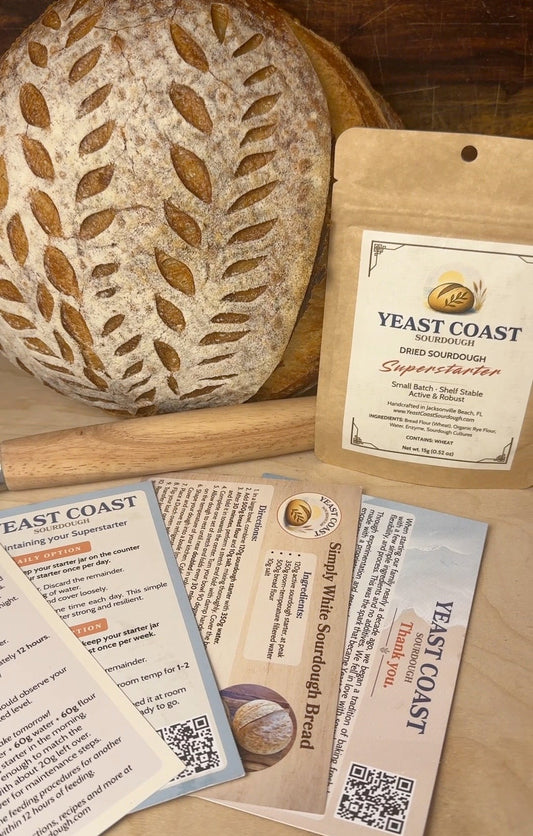 Loaf of bread with a Yeast Coast Sourdough package on a wooden surface